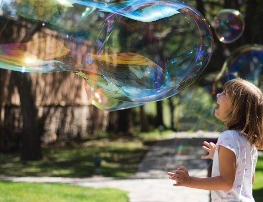 Girl playing with a giant bubble -MamiTalks.com